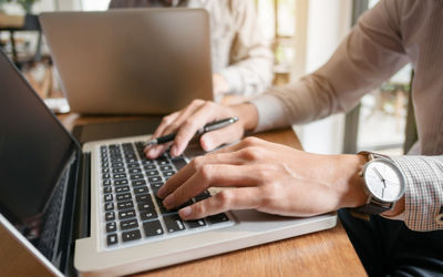 Midsection of man using laptop on table