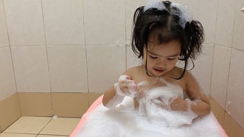 Girl in bathtub at home