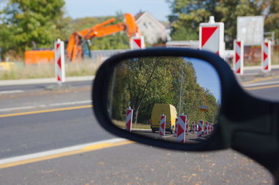 View of people on side-view mirror