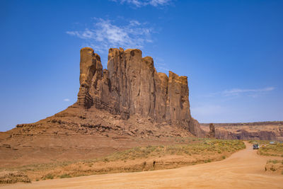 Rock formations on landscape against clear blue sky