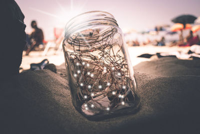  glass jar  on the sand 