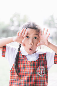 Close-up portrait of schoolgirl gesturing