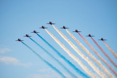 Low angle view of airshow against sky