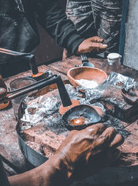 High angle view of man preparing food on barbecue grill