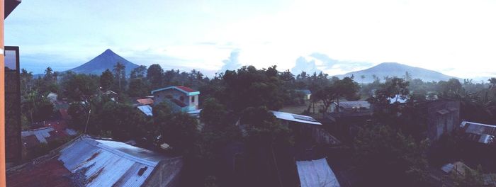 Panoramic view of trees and mountains against sky