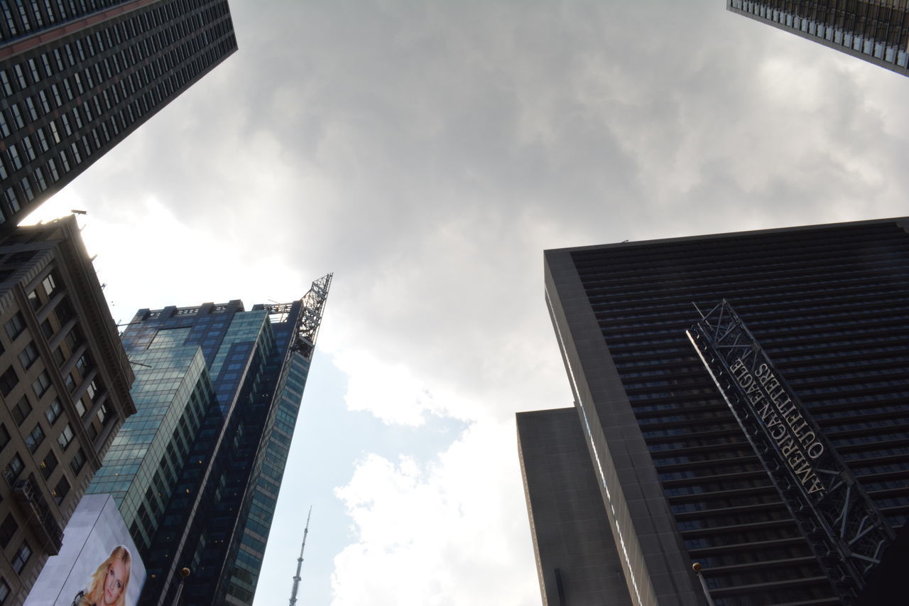 LOW ANGLE VIEW OF SKYSCRAPERS AGAINST CLOUDY SKY