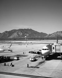 Scenic view of sea by mountains against sky