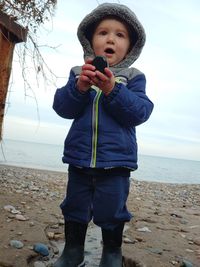 Full length of a boy standing on beach