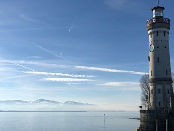 View of lighthouse by sea against sky