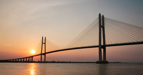 View of suspension bridge at sunset