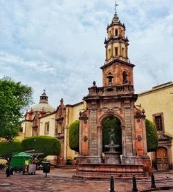 View of bell tower against cloudy sky