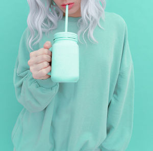 Midsection of woman drinking glass