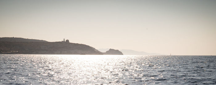 Scenic view of sea against clear sky during sunset