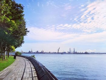 Scenic view of river by buildings against sky