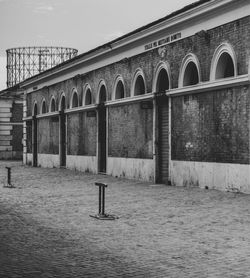 Arch bridge over river against building