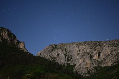 Scenic view of mountains against clear sky at night