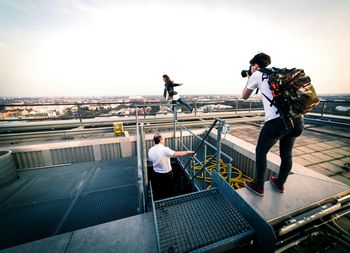 Full length of woman standing on railing