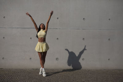Low section of woman with arms raised