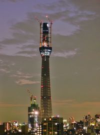 Low angle view of illuminated tower at night