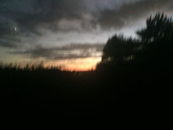 Scenic view of silhouette landscape against sky at sunset