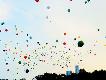 Low angle view of balloons against sky