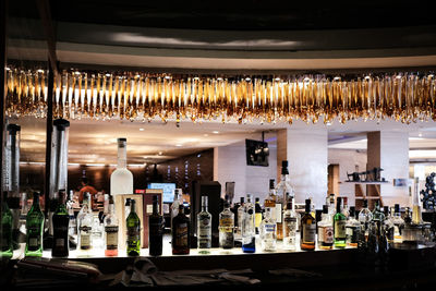 Row of wine bottles in glass