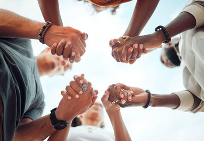 Midsection of couple holding hands