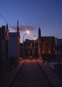 Street amidst buildings in town at night