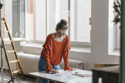 Young woman at table working on script templates