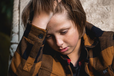 Close-up of young boy looking away