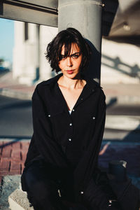 Portrait of young woman standing outdoors