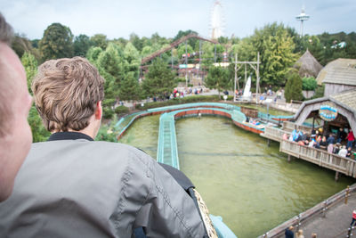 Rear view of man in river against sky