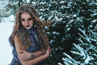 Portrait of young woman in snow