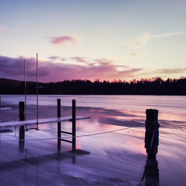 sunset, snow, winter, sky, tranquility, tranquil scene, cold temperature, scenics, nature, beauty in nature, season, weather, pole, tree, landscape, cloud - sky, fence, dusk, silhouette, street light