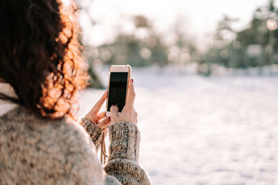 Rear view of woman using mobile phone