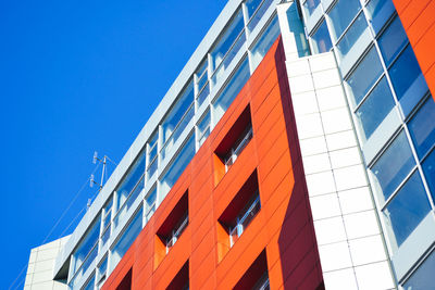 Low angle view of modern building against clear blue sky