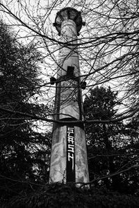 Low angle view of cross tower against sky