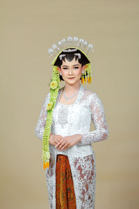 Beautiful model, wearing javanese indonesian wedding dress.