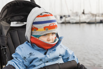 Close-up of baby girl wearing warm clothes while sitting in stroller