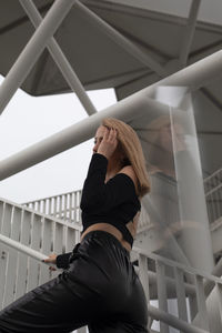 Low angle view of woman standing on staircase