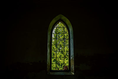 Close-up of illuminated window in darkroom