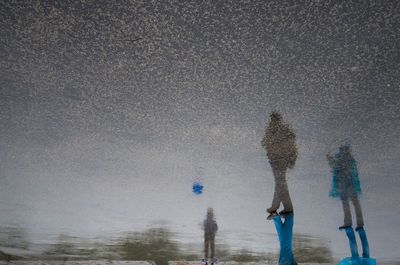 Low section of people with shadows on street