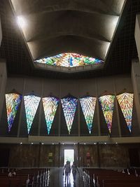 Low angle view of illuminated lights hanging on ceiling