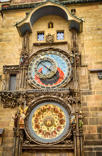 Low angle view of clock tower against building