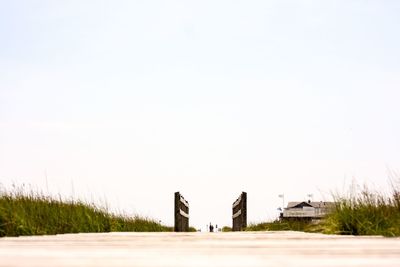 Scenic view of road by buildings against clear sky