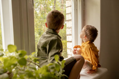 Side view of mother and daughter at home