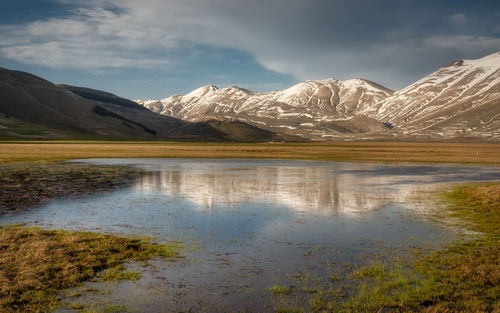 Scenic view of snowcapped mountains against sky