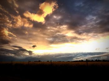 Scenic view of dramatic sky over field