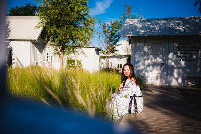 Portrait of woman against building