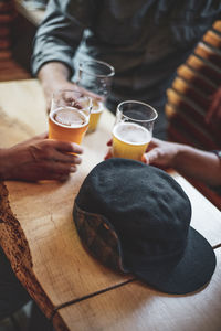 High angle view of man drinking glasses on table